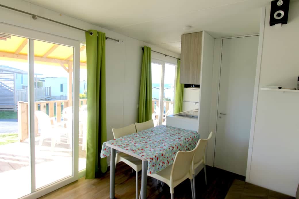 Bright living room with large bay window facing the sea