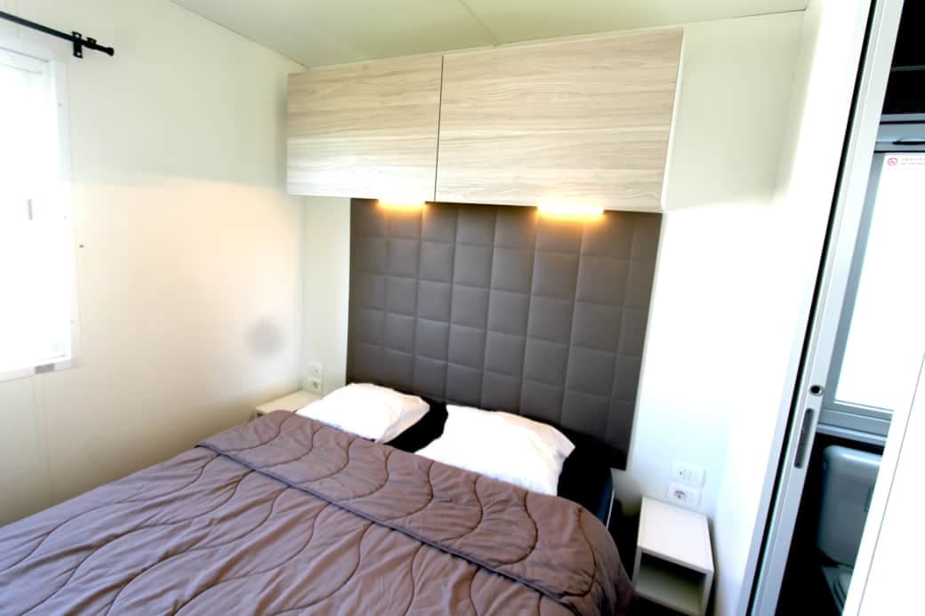 Master bedroom with queen bed and storage